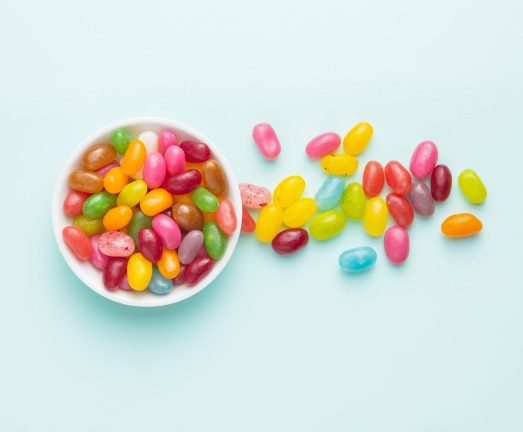 Fruity jellybeans. Tasty colorful jelly beans on colorful background.